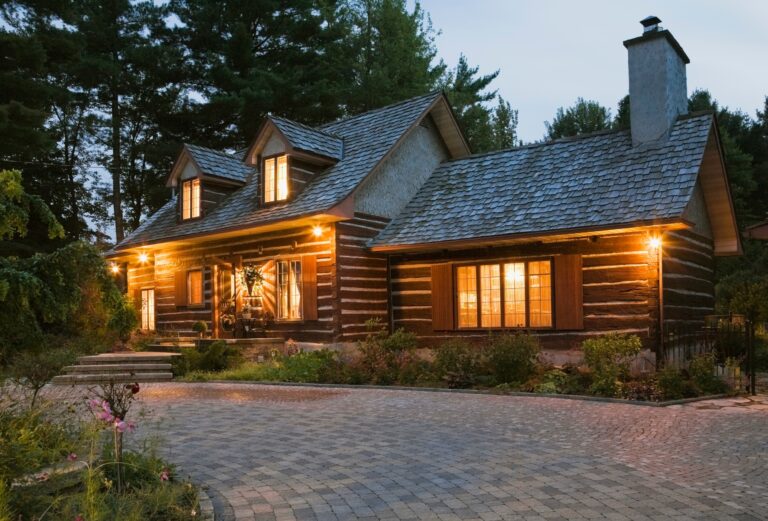 Reconstructed 1976 cottage style log home facade at dusk, Quebec, Canada
